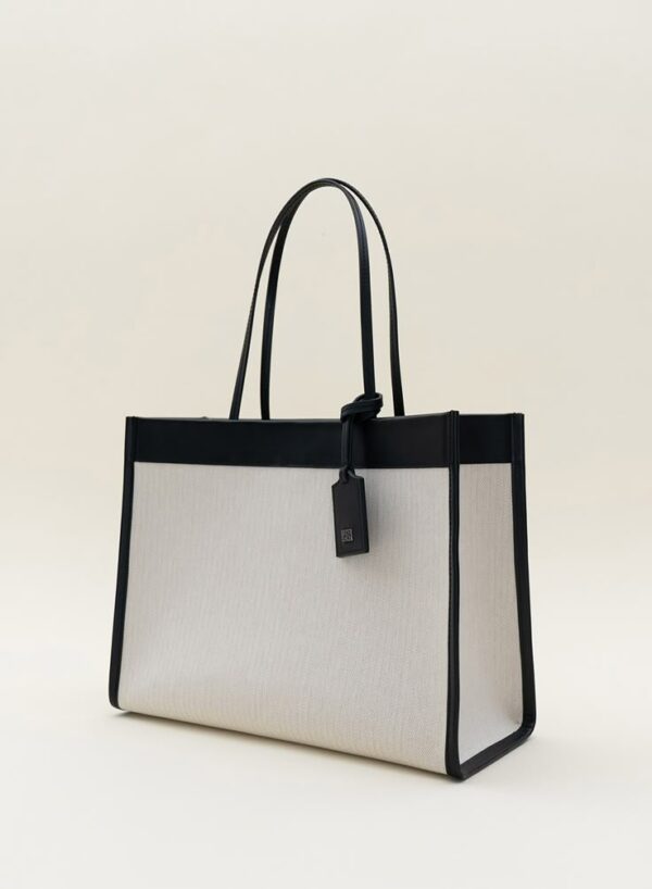 This elegant ladies' tote bag is the perfect blend of fashion and function. Designed with a spacious main compartment, it easily fits your everyday essentials such as a laptop, makeup pouch, water bottle, books, and more. Crafted from high-quality materials, it's durable enough for daily use while maintaining a sleek and stylish look. Comfortable shoulder straps ensure easy carrying, whether you're heading to work, running errands, or traveling. Multiple interior pockets help keep your items organized and accessible. With a secure zipper or magnetic closure, this versatile tote bag is both practical and chic—an everyday must-have.